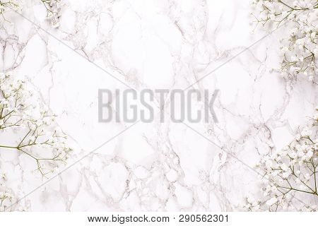 Floral Frame Of White Flowers On Marble Table Top View And Flat Lay Style.