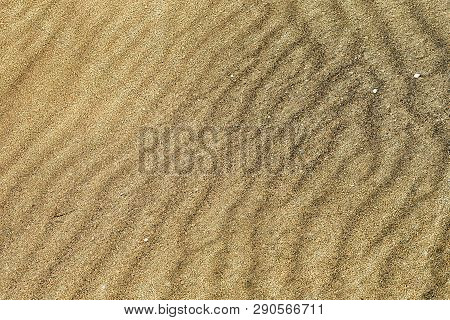 Yellow Sand Texture For A Background. Abstract Texture Waves On The Sand In The Desert. Patterns In 