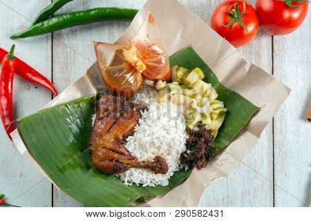 Nasi lemak kukus with chicken, popular traditional Malay local food.