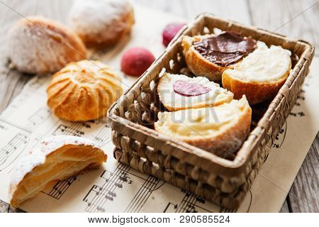 Homemade Profiteroles On The Music Sheet With Notes. Profiteroles (choux à La Crème) - French Choux