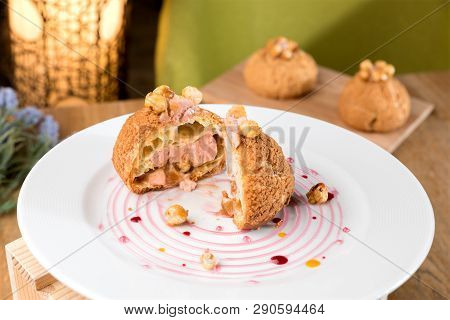 Homemade Violet Profiterole Served In White Plate.