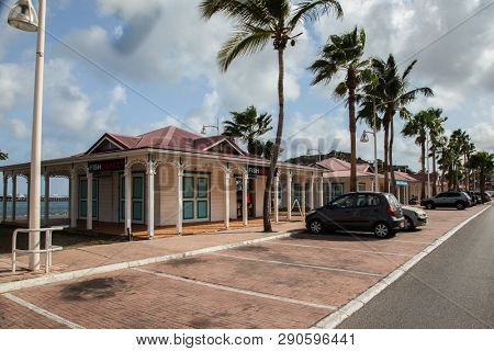MARIGOT, SINT  MAARTEN - JULY 31, 2015: Fish market landmark area in Marigot with parking on front.