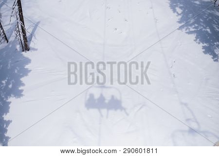 Shadow of the Ski lift on a snowy slope.