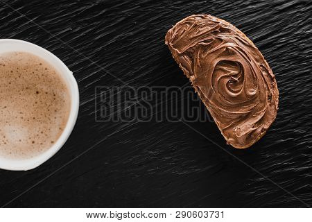 Coffee Cappuccino Or Latte Next To Bread With Chocolate On A Black Background Like Stone Mica