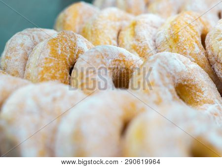 Bunch Of Doughnuts Cruller With White Powder Sugar Topping. Sweet Potato Donut. Selective Focus.