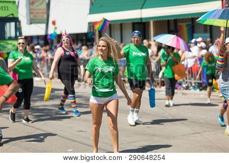 Chicago, Illinois, Usa - June 24, 2018: The Lgbtq Pride Parade, Men And Women Waving The Rainbow Fla