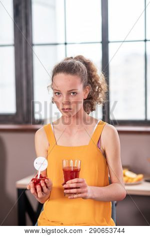 Curly-haired Disquiet Young Lady Having Unusual Food Diet