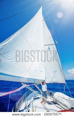 Little Boy On Board Of Sailing Yacht On Summer Cruise. Travel Adventure, Yachting With Child On Fami