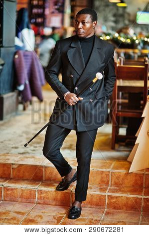 Stylish African American Gentleman In Elegant Black Jacket, Holding Retro Walking Stick As Cane Flas