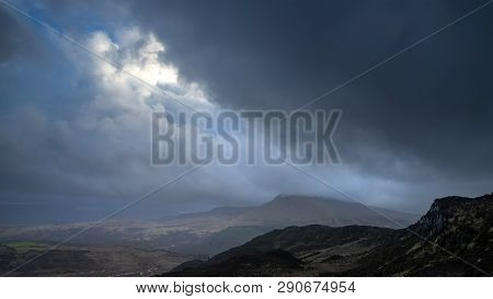 Dark And Dramatic Winter Landscape Image Of Moel Saibod From Crimpiau In Snowdonia With Stunning Sha