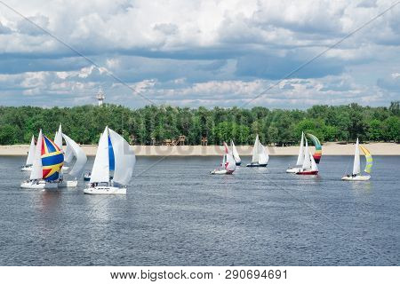 Regatta Competition Of Lake River Sailing Yachts Boats With Sails And Multicolored Gennakers, Reflec