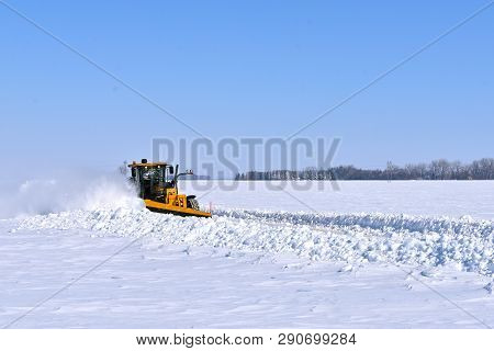 Moorhead, Minnesota, March 11, 2019:  The 772gp John Deere Road Grader Clearing A County Road Is A  