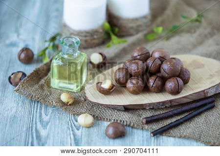 Macadam Nuts, Walnut Oil, On Wooden Background. Relax, Health Care, Body Care
