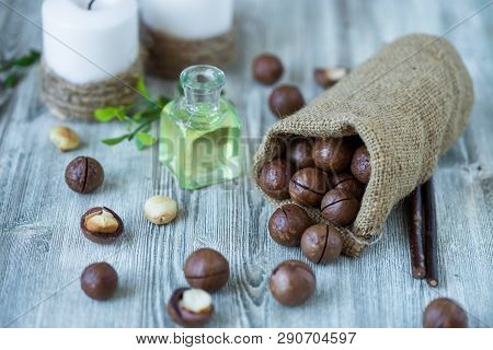 Macadam Nuts, Walnut Oil, On Wooden Background. Relax, Health Care, Body Care