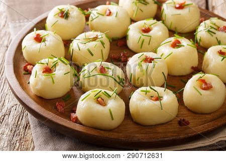 Polish Homemade Potato Dumplings With Bacon And Green Onions Close-up On A Plate On The Table. Horiz
