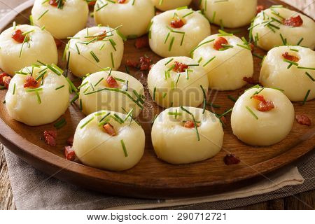 Polish Authentic Kluski Potato Dumplings With Bacon And Green Onions Close-up On A Plate. Horizontal
