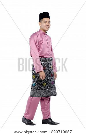 Portrait Of Young And Handsome Asian Man With Traditional Clothing During Hari Raya Over White Backg