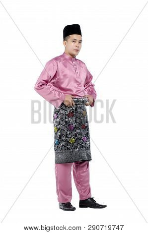 Portrait Of Young And Handsome Asian Man With Traditional Clothing During Hari Raya Over White Backg