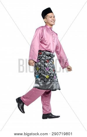 Portrait Of Young And Handsome Asian Man With Traditional Clothing During Hari Raya Over White Backg