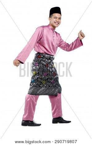 Portrait Of Young And Handsome Asian Man With Traditional Clothing During Hari Raya Over White Backg
