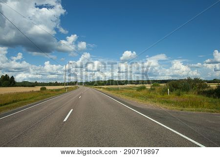 Fields, Trees And Road With Blue Sky And Clouds. Sun Day.