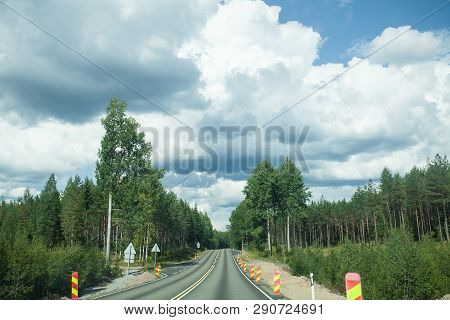 Road And Forest With Blue Sky And Clouds