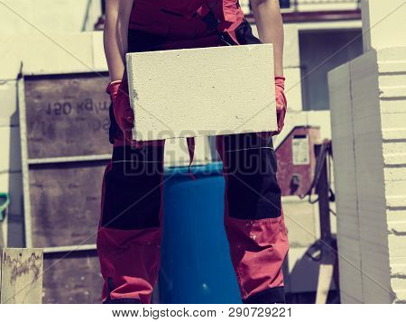 Unrecognizable Woman Working On Construction Site, Building House, Installing Gray Airbricks. Indust