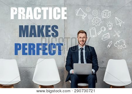 Smiling Businessman Sitting On Chair And Using Laptop In Waiting Hall With Practice Makes Perfect Le