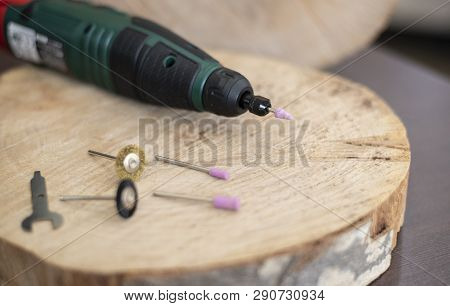 Drill Rotary Tool With Accessories, Dremel Tool Heads. Multi Tool On Wooden Table In Jeweler Worksho