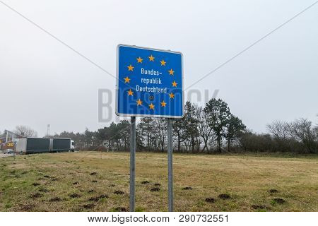 Handewitt, Germany - February 14, 2019: Federal Republic Of Germany Border Sign At Cloudy Day.