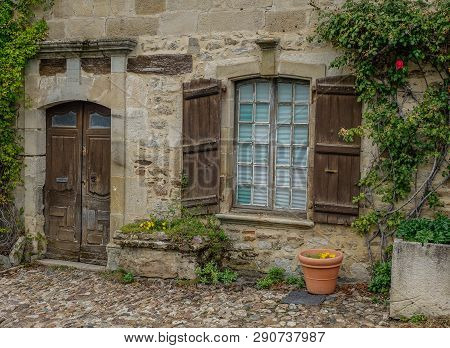 Najac, Midi Pyrenees, France - September 16, 2017: Old Stone Facade With Wooden Door And Window Surr