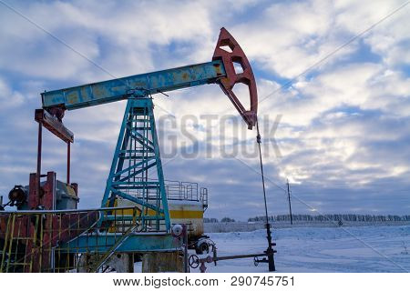 Oil And Gas Industry. Silhouette Oil Pumps On A Sunset Sky Background.oil Industry Equipment. Close 