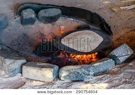Pita Bread Cooking On Fire In Bedouin Dwelling