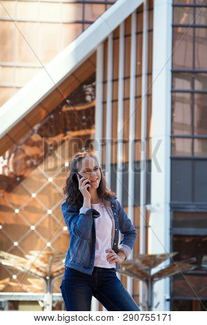 Happy Teen Girl Talk By A Mobile Phone Talk In A Large Metropolis