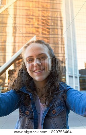 Portrait Photo Of Smiling Happy Teen Girl In A Street,big City