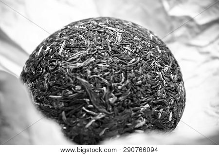 Chinese Pressed Puer Tea On Wrapping Paper, Close-up, Macro