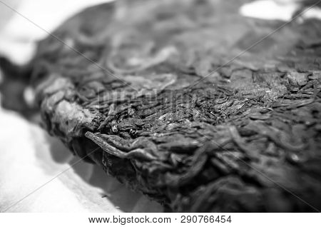 Chinese Pressed Puer Tea On Wrapping Paper, Close-up, Macro