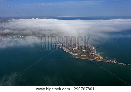 Aerial View Of Panoramic Seaport Warehouse And Container Ship, Crane Vessel Working For Delivery Of