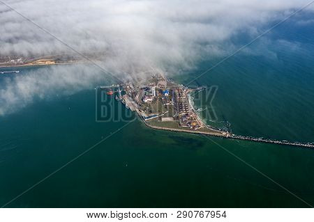 Aerial View Of Panoramic Seaport Warehouse And Container Ship, Crane Vessel Working For Delivery Of