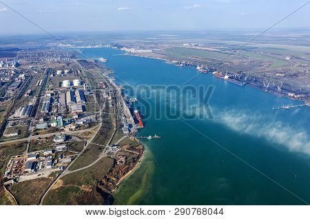 Aerial View Of Panoramic Seaport Warehouse And Container Ship, Crane Vessel Working For Delivery Of