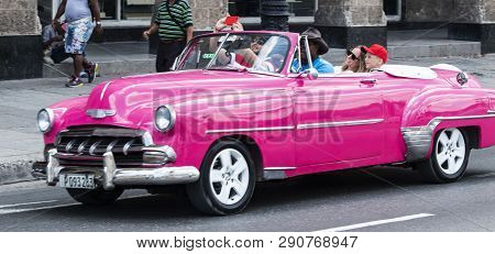 Havana, Cuba - 25 July 2018: A Family Is Being Driven Around Cuba While Taking A Selfie In An Old Cl