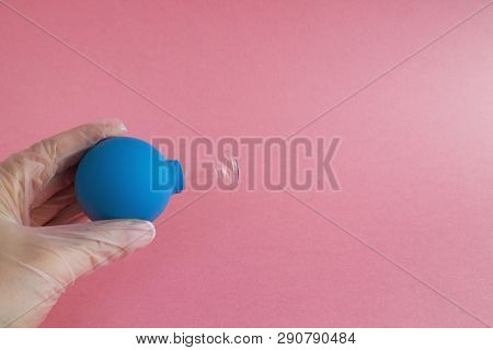 Female Hand With French Manicure In Medicine Glove Holds Blue Cosmetic Medical Jar For Vacuum Facial