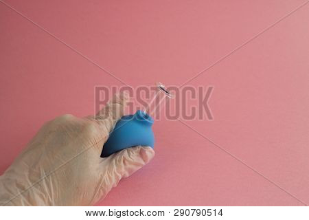 Female Hand With French Manicure In Medicine Glove Holds And Squeeze Blue Cosmetic Medical Jar For V