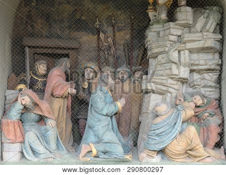 LUCERNE, SWITZERLAND - JUNE 24, 2018: Jesus on the Mount of Olives, surrounded by approaching soldiers and the Apostles, portal of the church of St. Leodegar in Lucerne, Switzerland