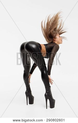 Erotic Woman In Leather Pants And Heels