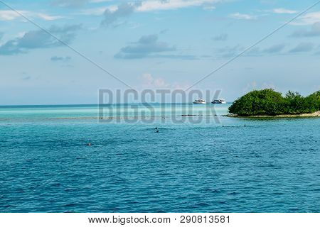 Maldives Background. Sunset Over The Tropical Sea And Coral Beach With Colorful Clouds In The Sky. B