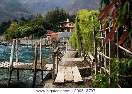 Boardwalk Along The Coast Along Lake Atitlan With Dark Blue Waves In The Village Jailbalito, Guatema