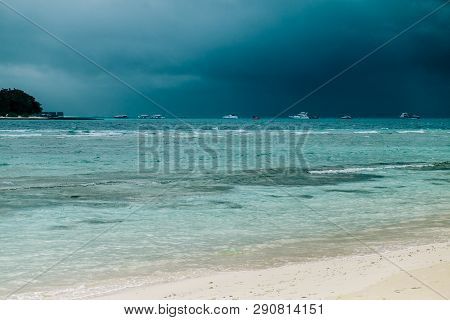 Maldives Background. Sunset Over The Tropical Sea And Coral Beach With Colorful Clouds In The Sky. B