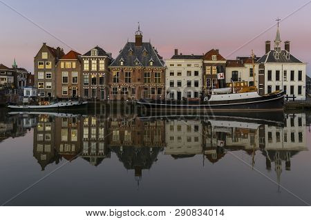 Maassluis, The Netherlands - February 26, 2019: The Harbor Of Maassluis With Old Boats, Tugs And Mon