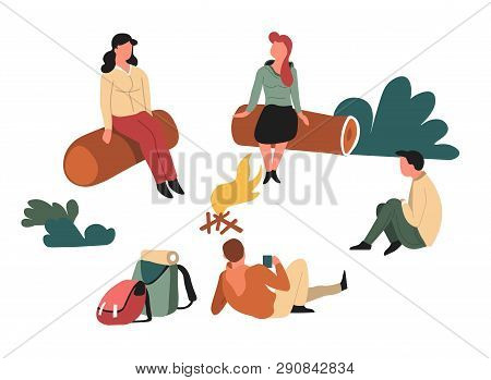 Hikers Sitting Around Campfire On Logs In Forest Backpacks